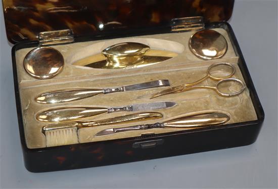 An Edwardian silver gilt manicure set, London, 1905/6/7 in Asprey tortoiseshell box, box 20.6cm.